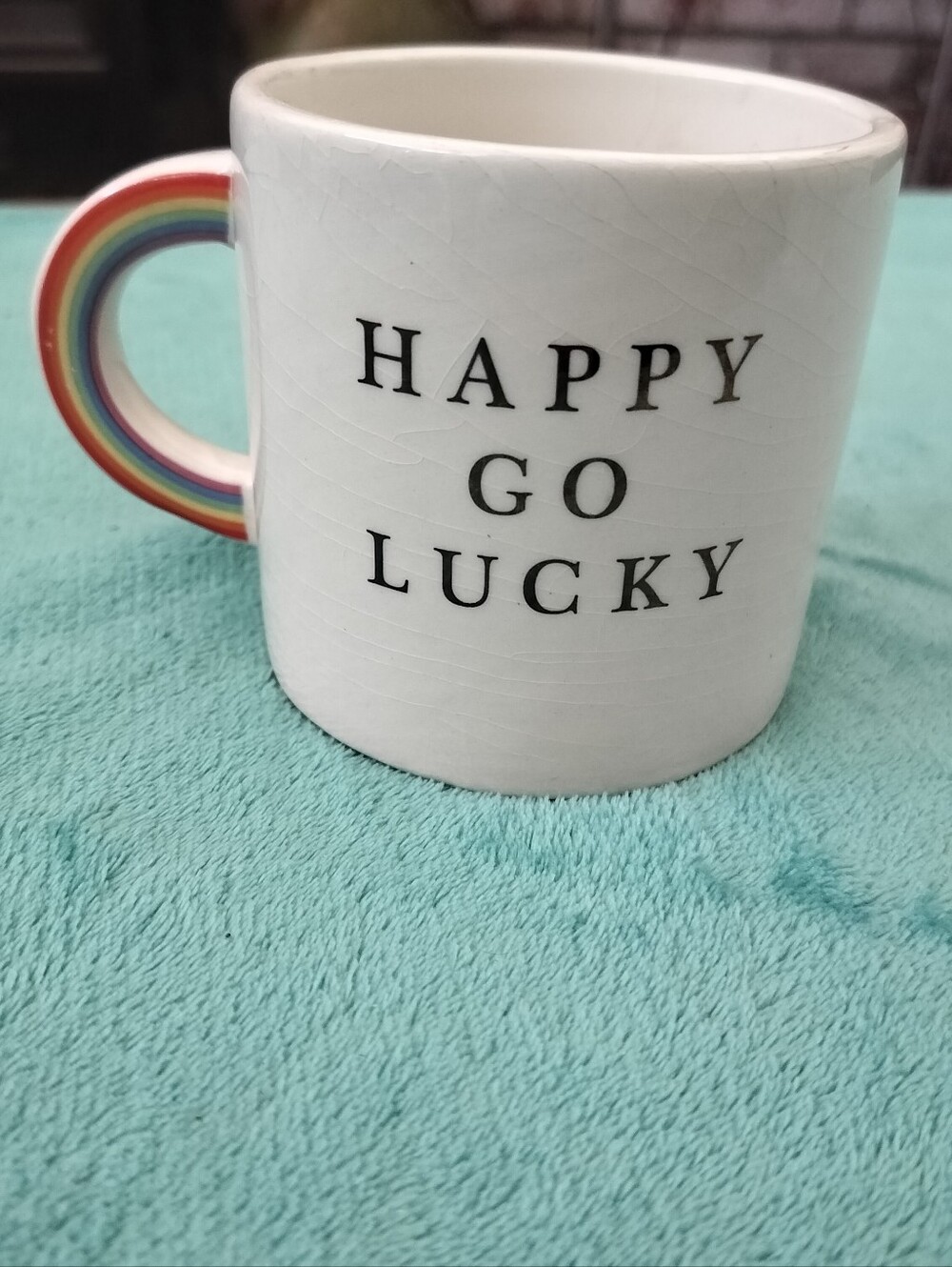 Happy Go Lucky White Ceramic Mug with Rainbow Handle Accent